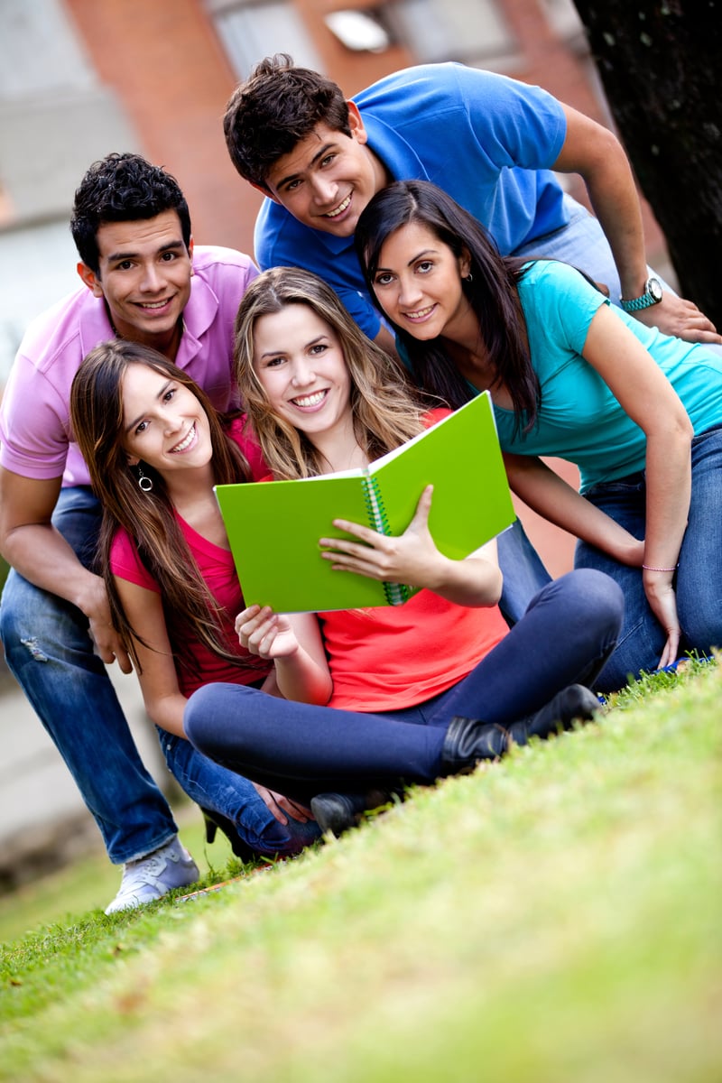 Bangladeshi students smiling at a university gate — studying in the UK