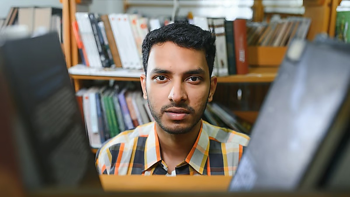 Bangladeshi student researching Bulgaria student visa requirements in a university library