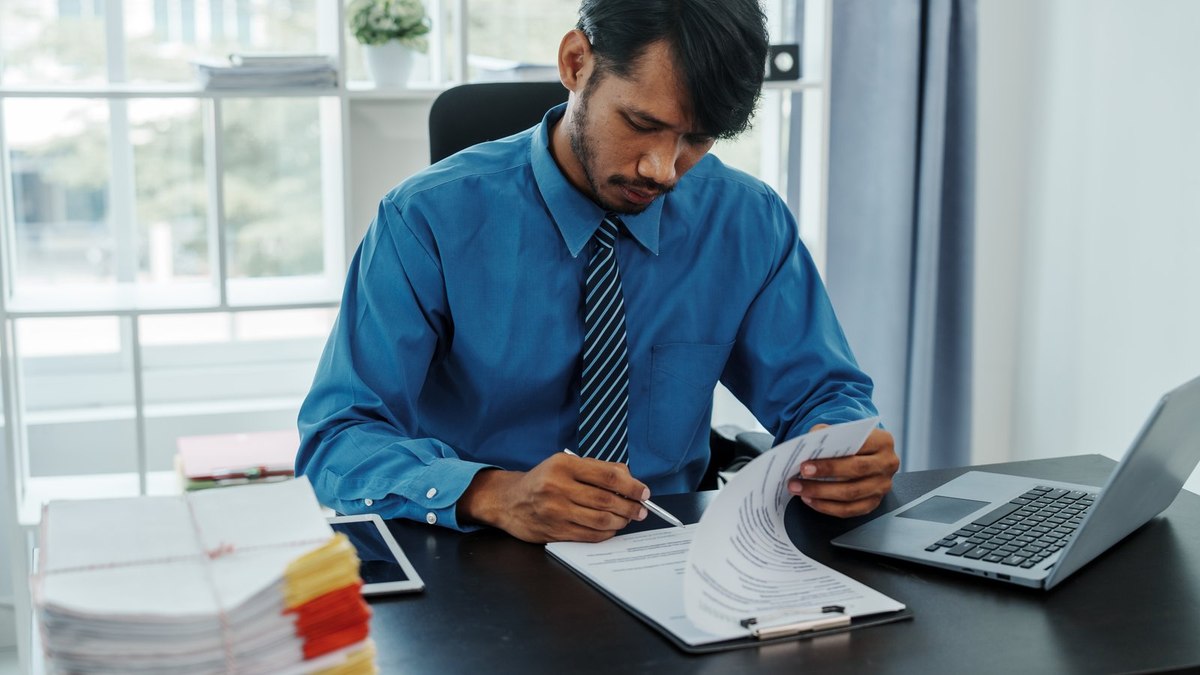 Bangladeshi student checking financial documents and bank statements for a Czech Republic long-term student residence permit application