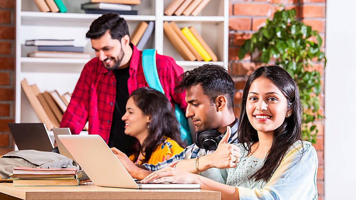 Bangladeshi and South Asian university students studying together with laptops, preparing an Estonia student visa application for 2027