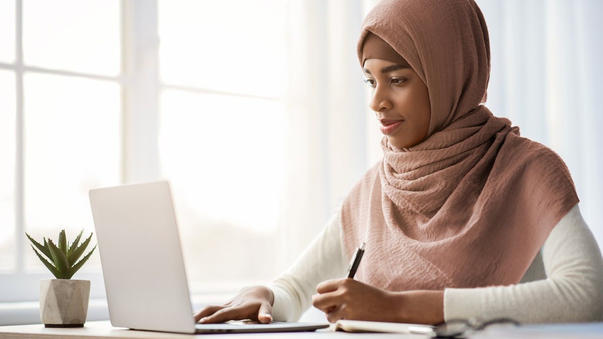 Student preparing a Stipendium Hungaricum scholarship application for Hungary on a laptop with documents