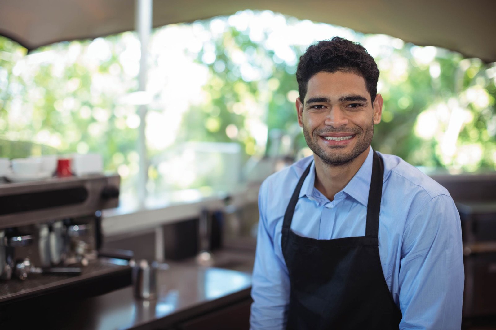 International student working a part-time job as a cafe assistant in Italy within the 20 hours per week limit on a study residence permit