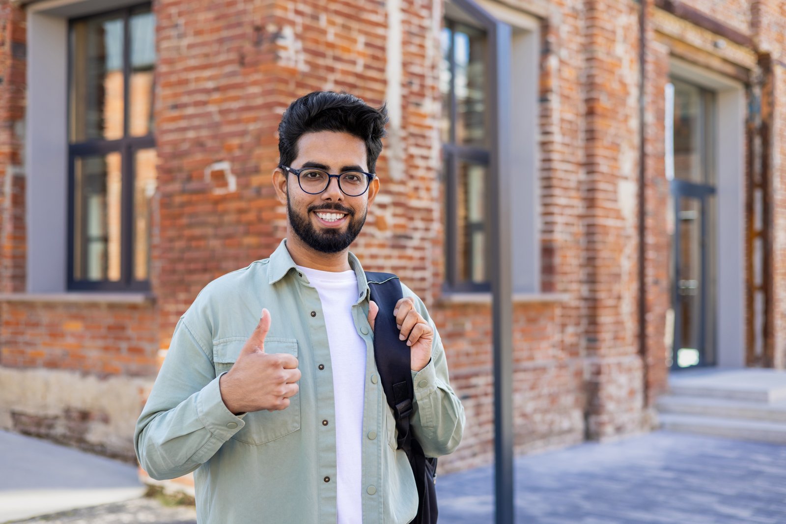 South Asian student with a backpack outside a university building, representing student life in Italy for Bangladeshi students in 2027