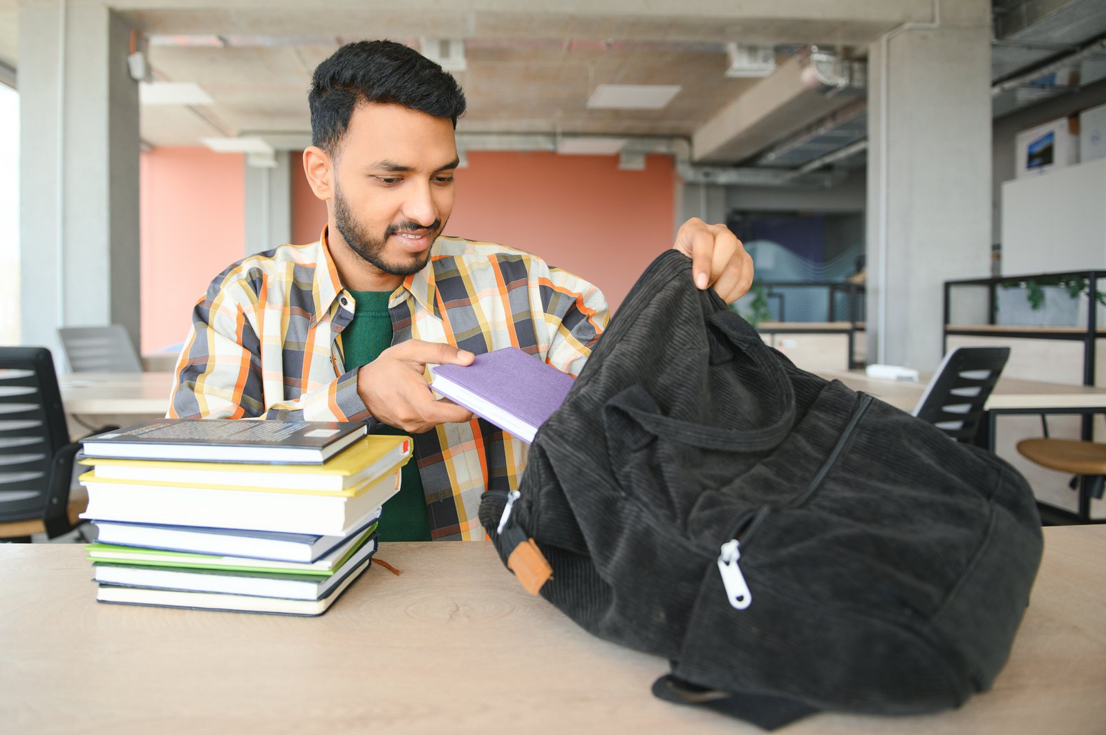 Bangladeshi student organising books and documents for an Italy student visa application in 2027