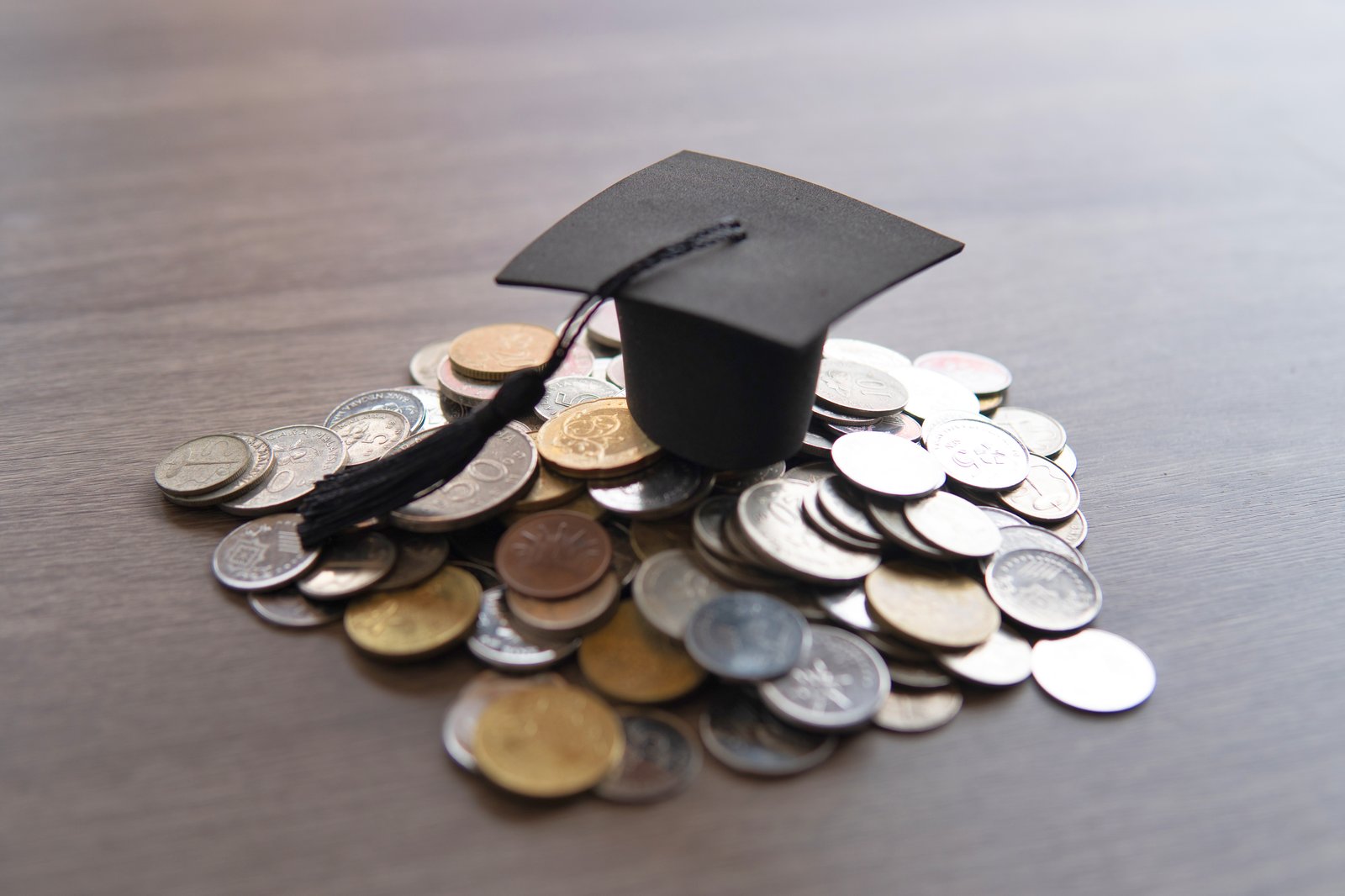 Graduation cap resting on Malaysian ringgit coins — scholarships in Malaysia for Bangladeshi students 2027