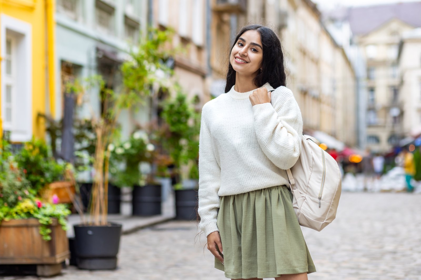 South Asian student with a backpack on a Mediterranean city street, everyday student life in Malta for Bangladeshi students