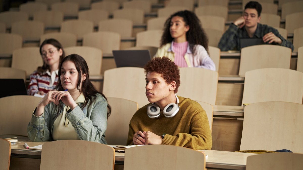 International students attending a lecture in a European university hall, representing study options in Poland for Bangladeshi students