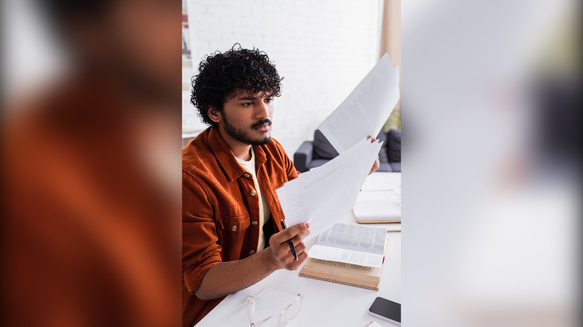 Bangladeshi student reviewing Russia student visa documents and university application papers