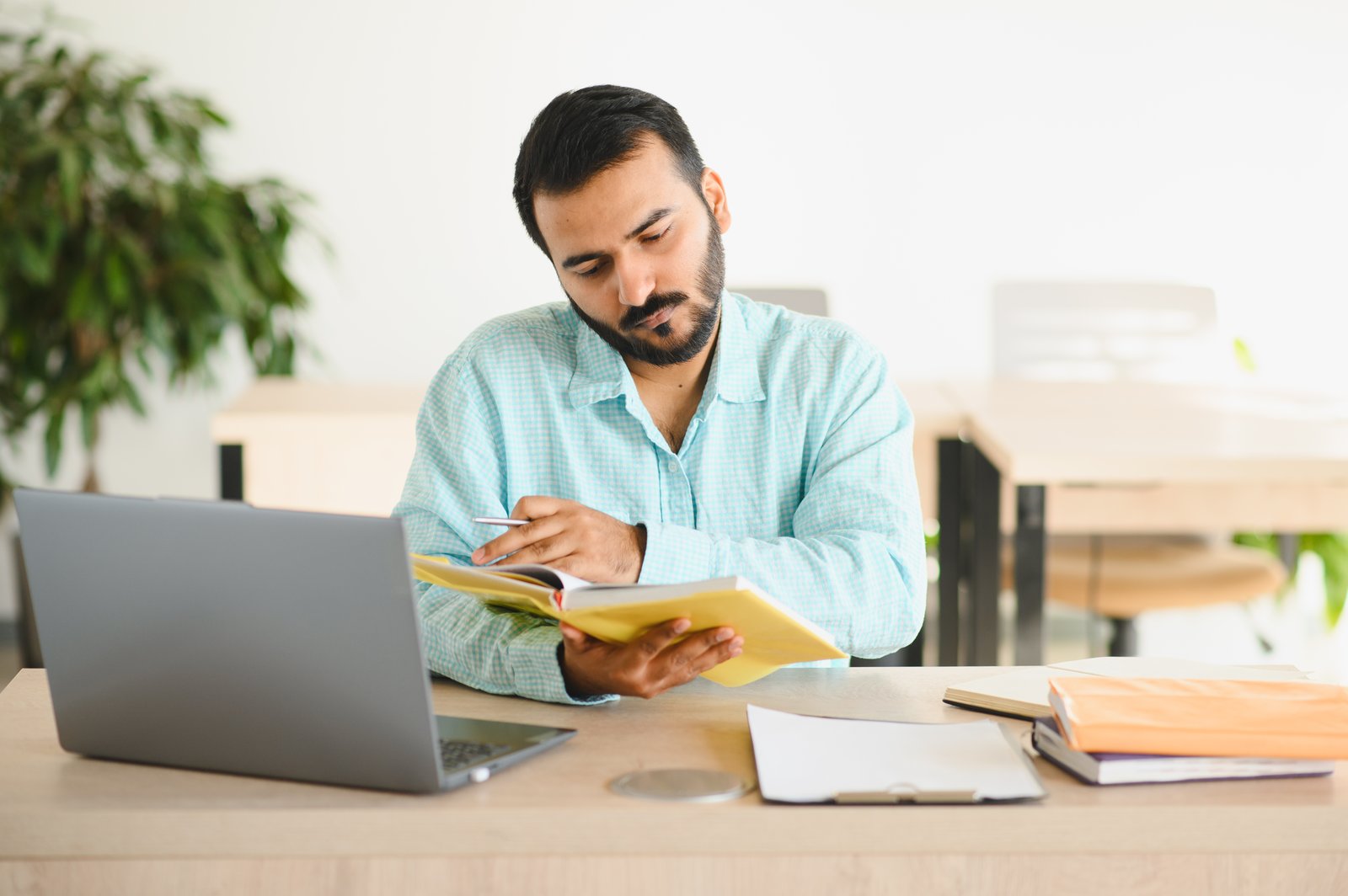 Bangladeshi student preparing Serbia student visa documents and university paperwork at a desk