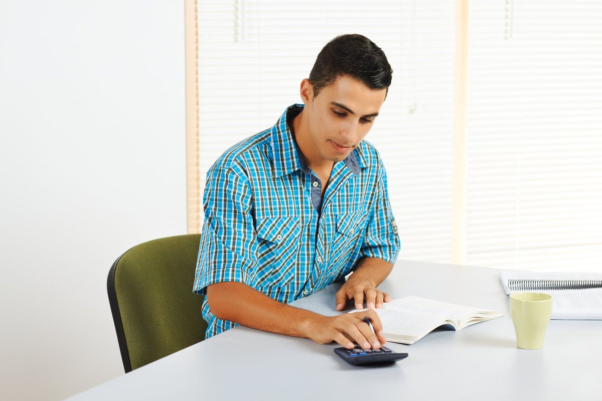 Student comparing university tuition fee price lists while preparing a Slovenia student visa application from Bangladesh