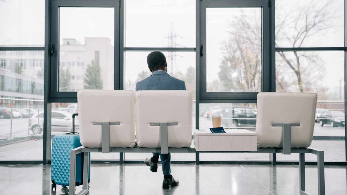 Bangladeshi traveller waiting at an airport departure lounge before flying to Thailand on a tourist visa