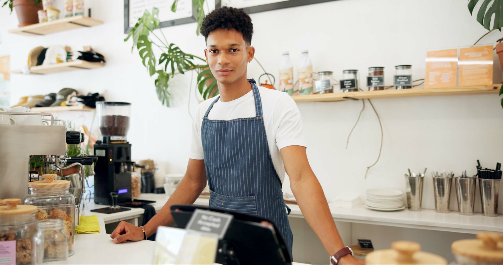 International student working a part-time barista job in a UK cafe within the 20 hours per week term-time limit